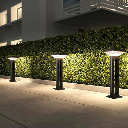 Ark Series Solar Lawn Light CPD1201 lighting a hedge pathway beside a modern residential building
