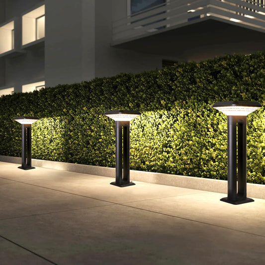 Ark Series Solar Lawn Light CPD1201 lighting a hedge pathway beside a modern residential building