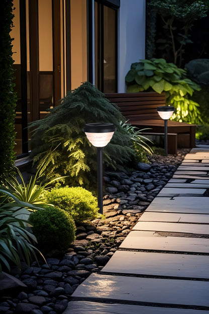 Little Conch Series Solar Lawn Light CPD1618 used beside a garden walkway and landscape plants