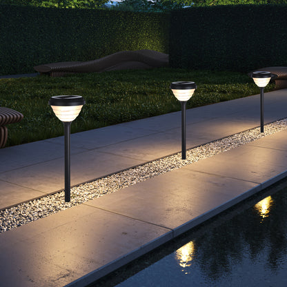  Little Conch Series solar lawn lights illuminating a waterfront pathway and gravel border at night