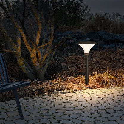 Round Diamond Series Solar Lawn Light CPD3002 illuminating a patio border and landscape plants at night