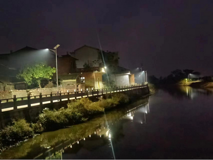 Super Crystal split solar street light installed along a riverside village road for night outdoor lighting